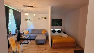 a living room with a couch and a bed at Apartament Joanna in Wadowice
