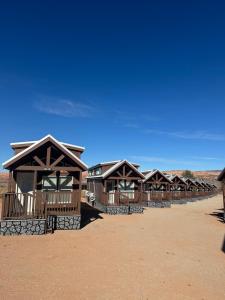 a row of wooden huts in the desert at Arches Hut in Moab