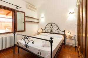 a bedroom with a bed and a mirror and a window at Villa Sa Marina con piscina in Bari Sardo +19 photos