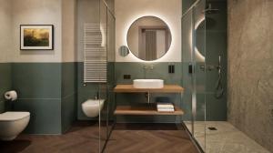 a bathroom with a sink and a toilet at Hotel Giacomo Morra Alba - Handwritten Collection in Alba
