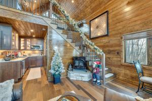 a woman standing in a living room with a staircase in a house at Couples Getaway in Stoney Creek at Wintergreen! in Nellysford
