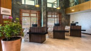 a lobby with a waiting area with a potted plant at Courtyard by Marriott Puerto Montt in Puerto Montt