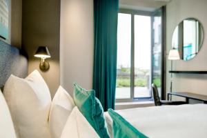 Ein Bett oder Betten in einem Zimmer der Unterkunft Motel One Ulm