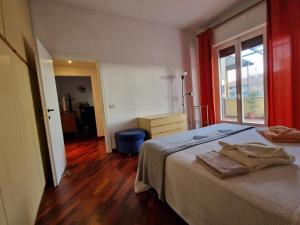 a bedroom with a large bed and a window at Trilly's House is waiting for you! Panoramic Penthouse in Florence