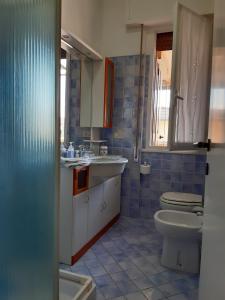 a bathroom with a toilet and a sink at Trilly's House is waiting for you! Panoramic Penthouse in Florence
