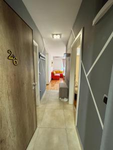 a hallway with a door and a living room at Sarajevo Bulevar in Sarajevo