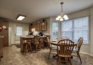 a kitchen and dining room with a table and chairs at Henderson's Riverside in Pigeon Forge +20 photos