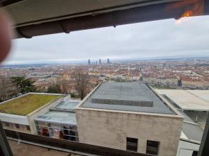 a view of a city from a window of a building at Suite Lodge in Lyon