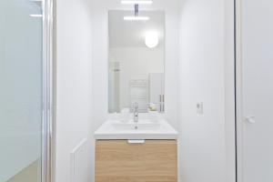 a bathroom with a sink and a mirror at Cozy studio near Paris & Orly in Vigneux-sur-Seine