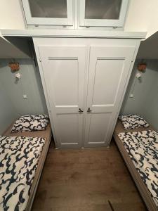 a small room with two beds and a cabinet at Appartement Le Zenith à Verbier in Verbier +2 photos