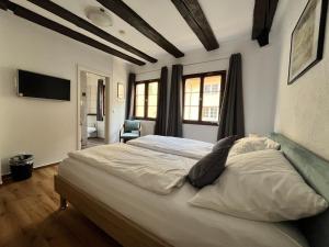 a bedroom with a large bed in a room at Gästehaus AM HAFEN in Meersburg