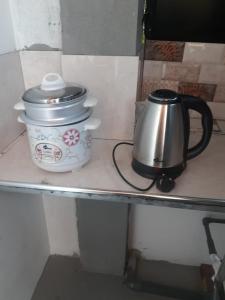 a tea pot sitting on top of a counter at Pathum Guest House Midigama in Midigama +16 photos