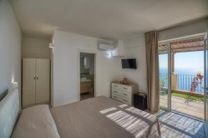 a bedroom with a bed and a view of the ocean at Tenuta La Picola in Furore