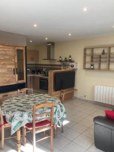 a living room with a table and a kitchen at Lappart in Seyssel +14 photos