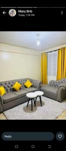 a living room with a couch and a table at Hadassah apartment in Nairobi
