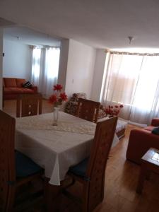 a dining room with a table with a vase of flowers on it at Fresnos 14 Queretaro in Mendiola