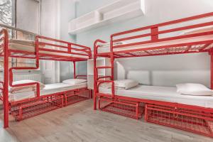 two red bunk beds in a room at Astor Victoria Hostel in London