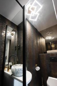 a bathroom with a sink and a shower at Apartament Jacuzzi in Gdynia