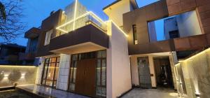 a facade of a building with a balcony and a door at Rustic Homestay Sonipat in Sonīpat