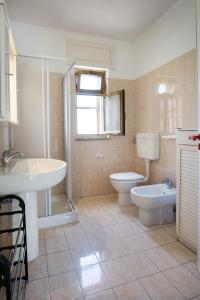 a bathroom with a sink and a toilet and a shower at Casa del Sole - Grande by Salento Prime in Marina di Pescoluse