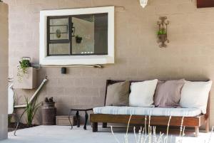 a couch sitting in a living room under a window at Cape Karoo Cottage in Harkerville