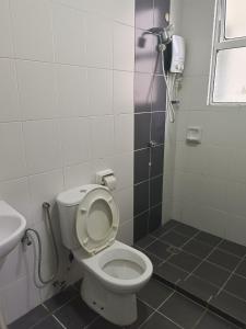 a bathroom with a toilet and a sink at IJM Condostay, Sandakan in Sandakan