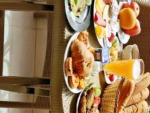 a bunch of plates of food on a table at Pyramids Heritage suites in Ghaţāţī