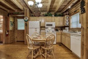 a kitchen with a table and chairs in a cabin at A Smoky Getaway in Sevierville