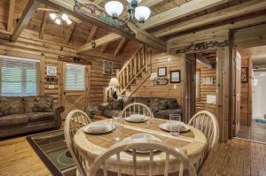 a dining room with a table and chairs at A Smoky Getaway in Sevierville