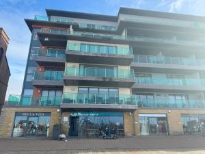 a tall apartment building with a store front at Pears Suite - 1 Bedroom - Sleeps 2 in Whitehaven