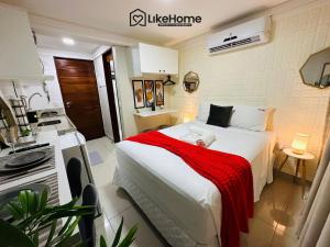 a bedroom with a bed with a red blanket on it at Mar Bello in Ilha da Restinga +43 photos