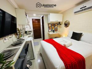 a bedroom with a bed with a red blanket on it at Mar Bello in Ilha da Restinga