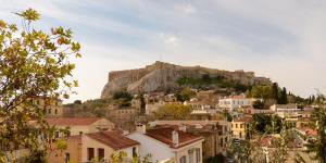 a view of a town with a mountain in the background at Euphoria Apartments Monastiraki in Athens