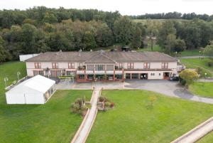 an aerial view of a large house with a yard at Domaine de Pousiniès in Saint-Étienne-de-Tulmont
