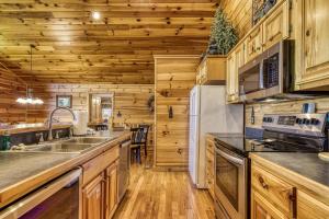 a kitchen with wooden walls and wooden counters at Getaway Mountain Lodge in Sevierville