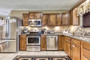 a kitchen with wooden cabinets and stainless steel appliances at Bear Run in Sevierville