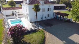an aerial view of a house with a swimming pool at Condrine in Doazit