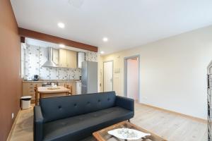 a living room with a couch and a kitchen at Cómodo y económico by CABANA Rentals in Vigo +9 photos