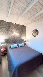 a bedroom with a large bed with blue sheets at Villa Océan Labenne Plage in Labenne