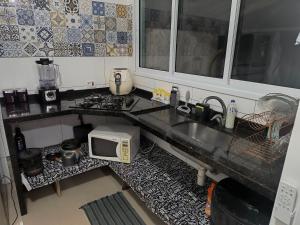 Η κουζίνα ή μικρή κουζίνα στο Casa em Boiçucanga - Temporada, finais de semana e feriados +8 φωτογραφίες