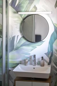a bathroom with a sink and a mirror at Ferienwohnungen Brugger in Obermaiselstein +24 photos