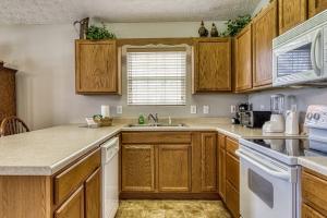 a kitchen with wooden cabinets and a sink at Lee's Creekside in Pigeon Forge