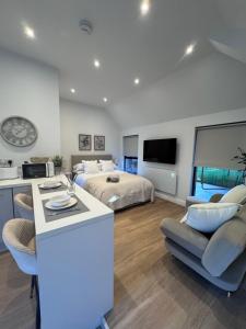 a bedroom with a bed and a kitchen with a counter at Tithe Cottage in Tamworth