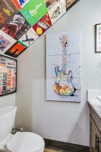 a bathroom with a painting of a guitar on the wall at Music Hall Brand New 2BR 2 and a half BA in San Angelo +37 photos