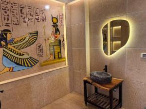 a bathroom with a sink and a mirror at Pyramids Rafif Hotel in Cairo