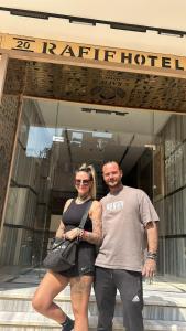 a man and a woman standing in front of a building at Pyramids Rafif Hotel in Cairo