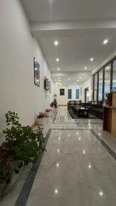 a lobby with couches and potted plants in a building at The Shava Ladakh in Leh