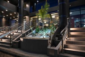 a lobby of a building with stairs and plants at فندق فيوليت الفندقية Violet Hotel in Yanbu
