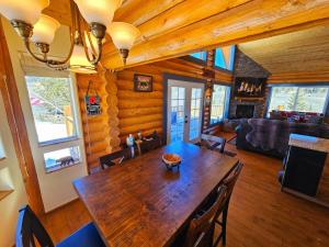 a dining room and living room with a wooden table at Stunning 2 Bedroom 1.5 Bath Cabin on 3.5 Acres in Bordenville