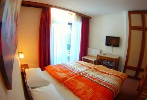 Postel nebo postele na pokoji v ubytování Hotel Canin